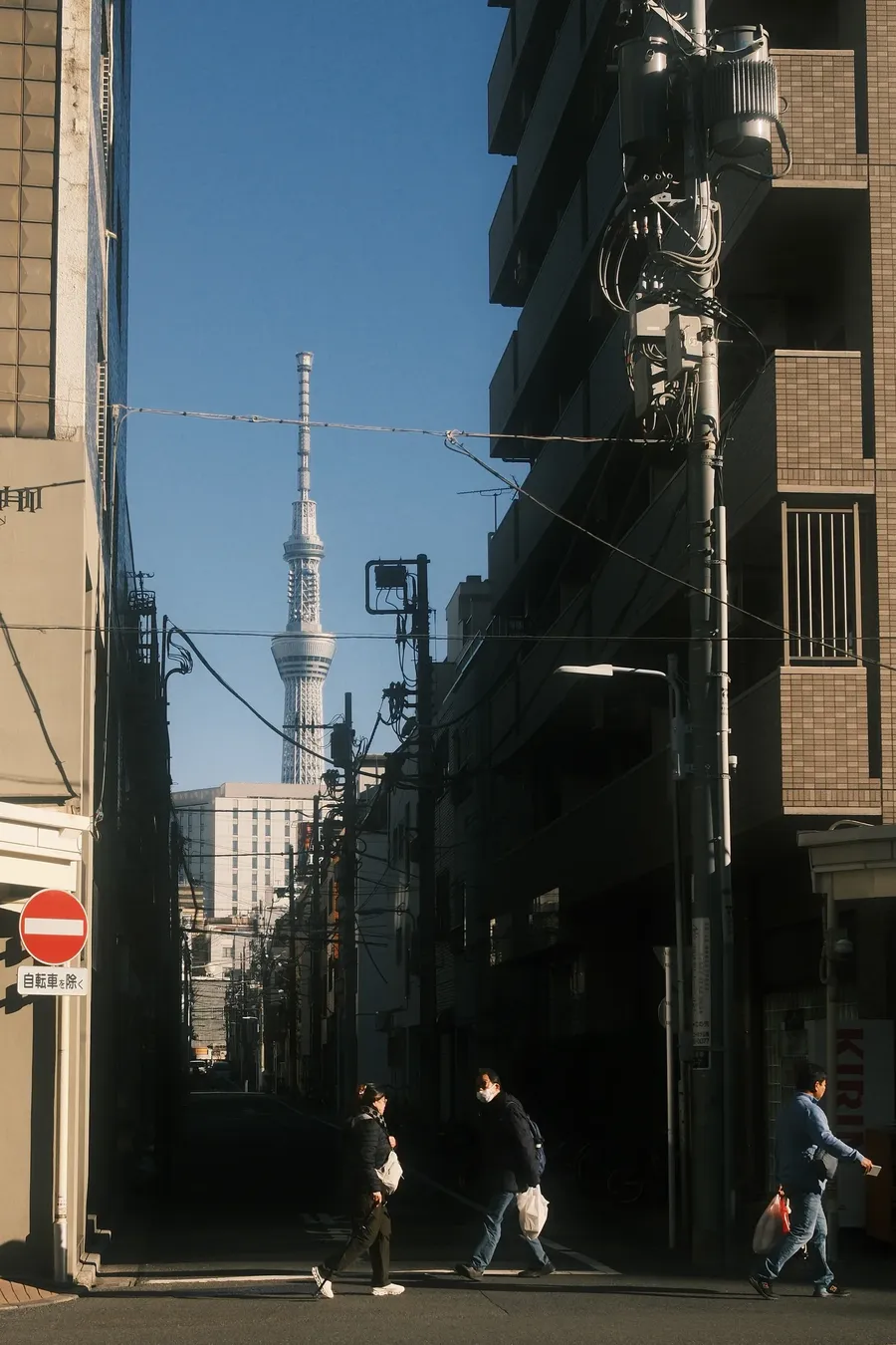 A Tokyo backstreet with the Skytree standing at the end of it.