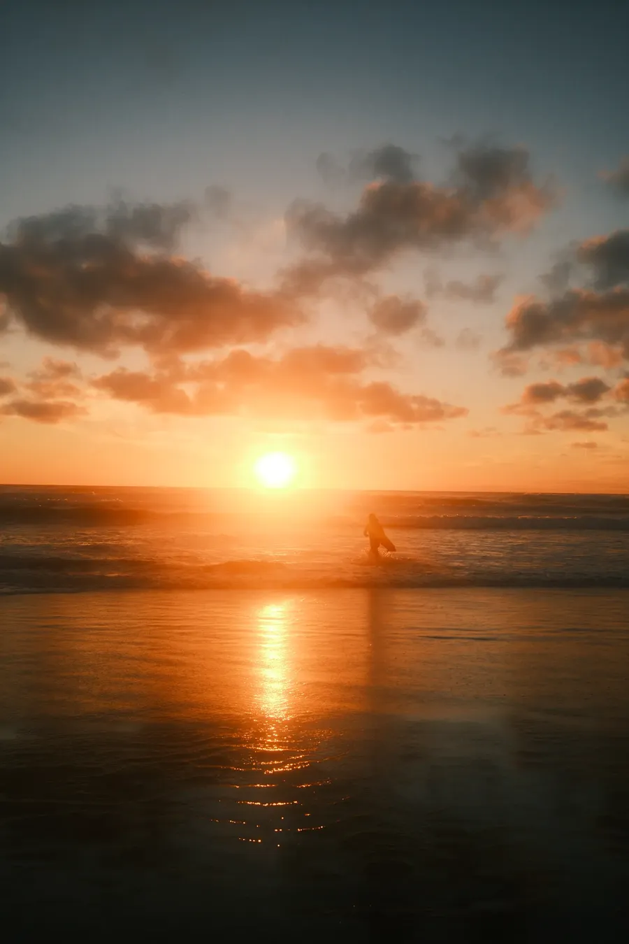 The sun setting into open water.
