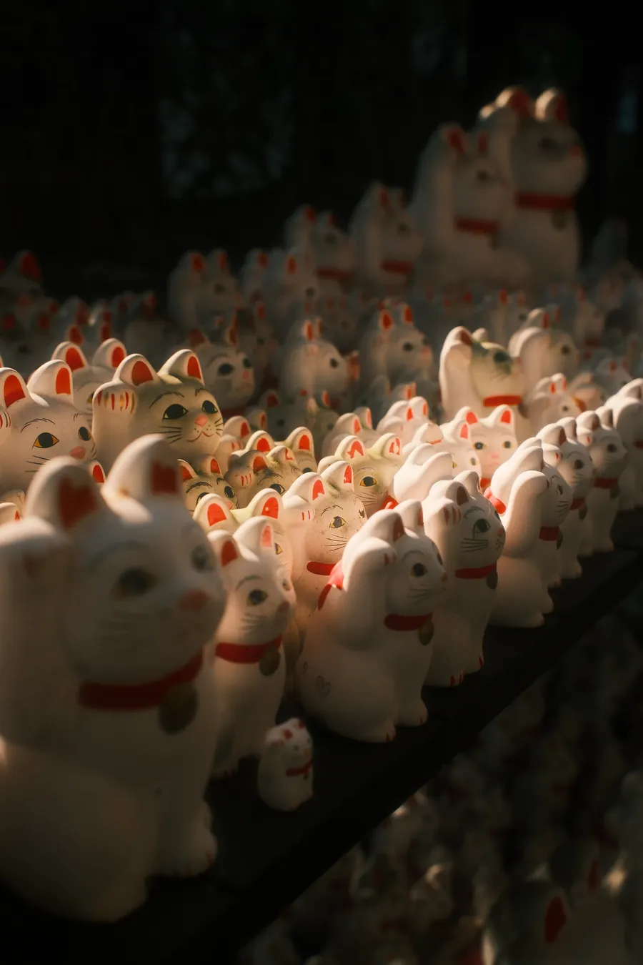 Rows of small beckoning cat figures.