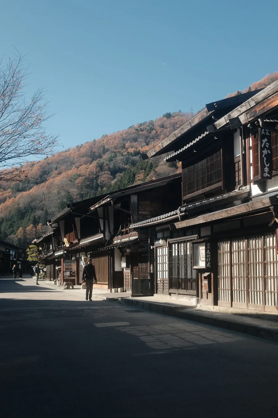 An empty street of old wooden buildings.