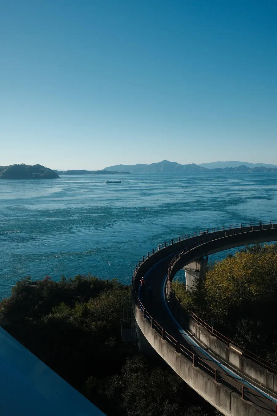 A railway curving along a coastline.