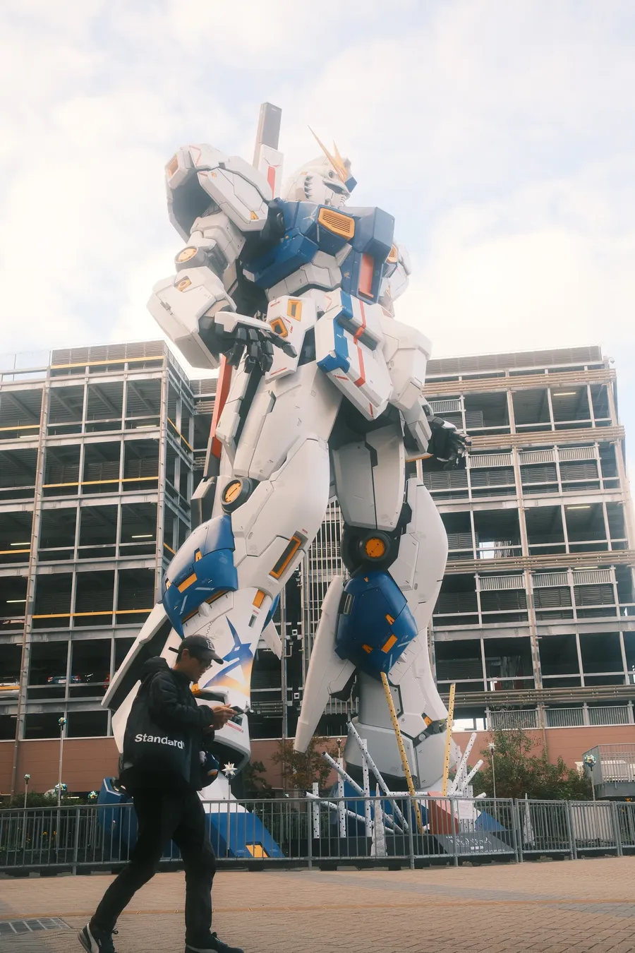 A life-size robot statue above a plaza.