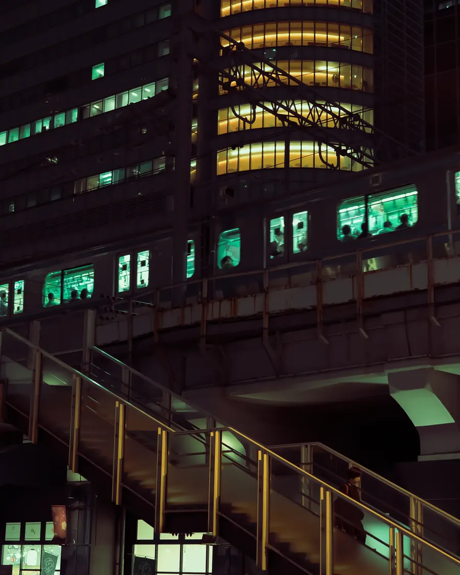An office building lit green at night.