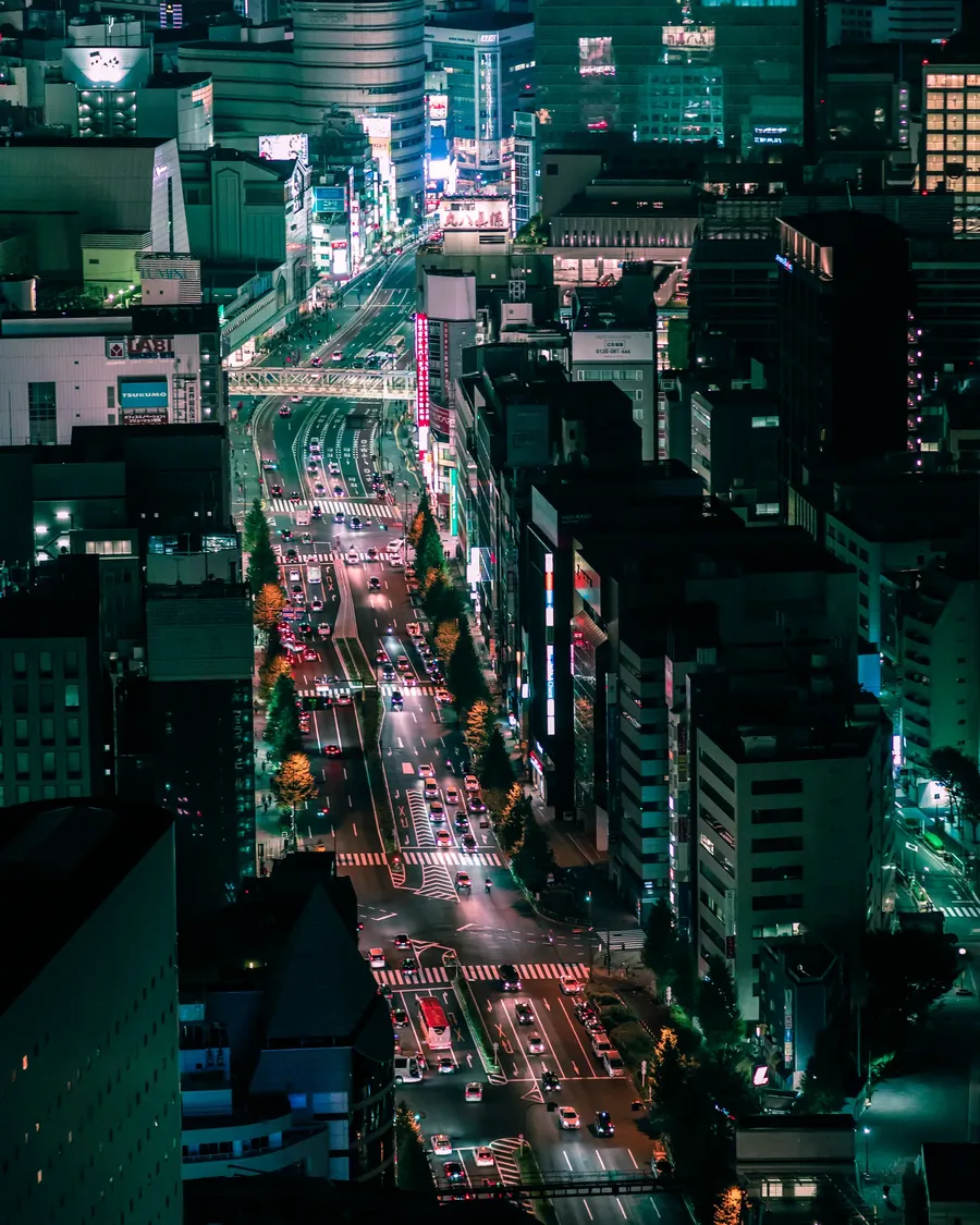 A neon crossing seen from above at night.