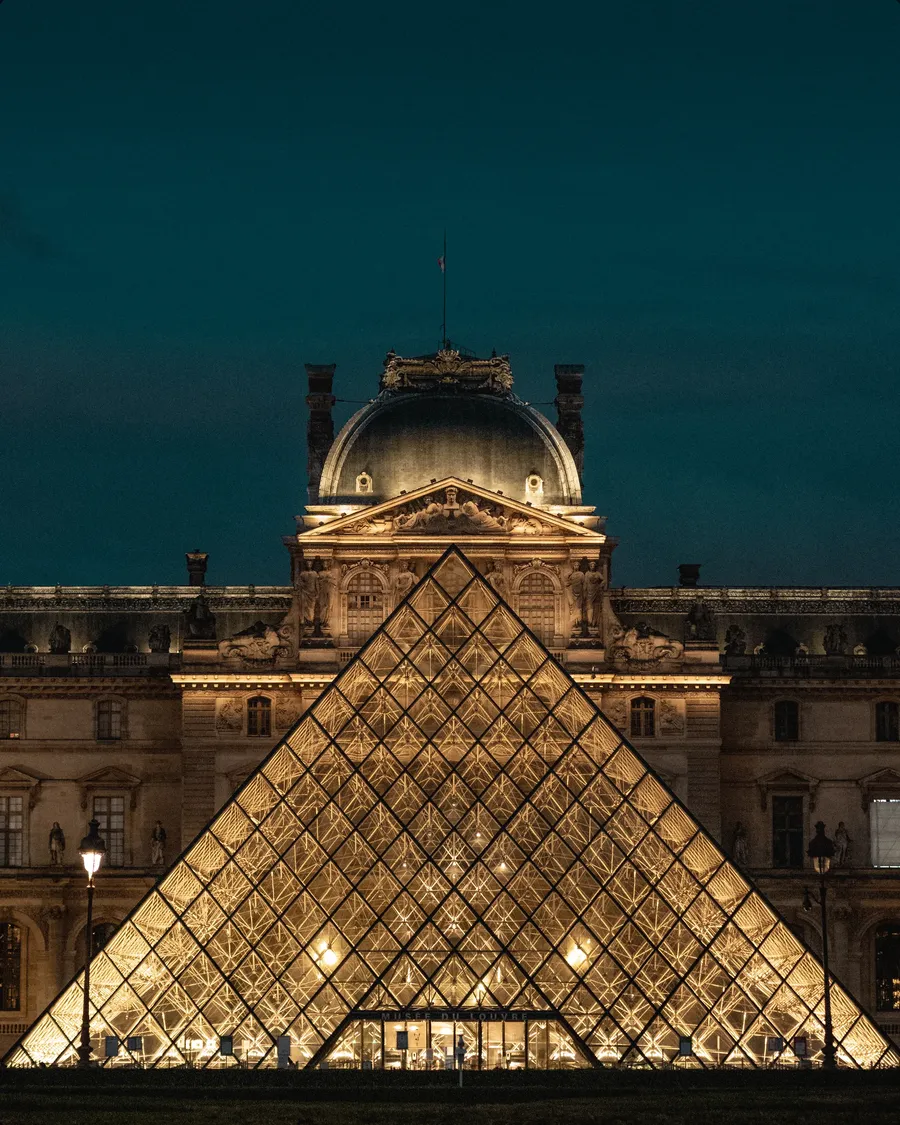 The Louvre pyramid lit after dark.